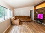 Spacious Living Room with Vaulted Ceilings. Custom Wood Laminate Flooring.
