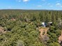View of the back of the home from the canyon taken via drone