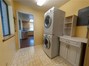 Bright and cheery laundry room is off the kitchen