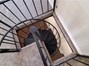 View looking down the spiral staircase toward living room below.
