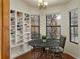 Off the kitchen is a dining nook with tons of shelves for extra storage and a view of the backyard