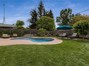 Large yard with lawn, garden and pool