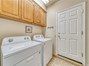 Separate Laundry Room with plenty of Storage Cabinets!