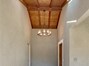 Formal breezyway with skylights and beautiful light fixture.