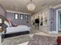 Downstairs Master Suite...Note the Beautiful Crystal Chandelier & the Delailed Wall Unit.