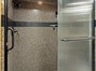 Tile walk-in shower and privacy toilet area.
