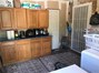 Room off kitchen with washer, dryer and tons of storage