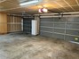 Garage features storage cabinets and automatic garage door opener.
