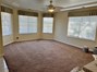 Spacious living room with an abundance of windows to let in the natural light.