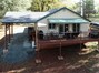 Guest home's aerial picture of the large deck &amp covered carport.
