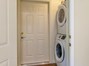 Laundry closet with stackable washer and dryer in the apartment.