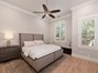 Spacious guest suite on main level with custom shutters...